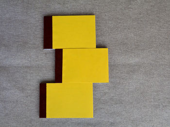 Directly above shot of yellow paper on table