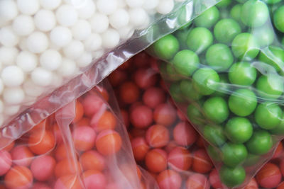 Close-up of colorful balls in plastic bags for sale at market