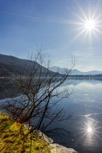 Scenic view of lake against sky on sunny day