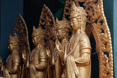 Close-up of golden buddha statues in linh phuoc pagoda