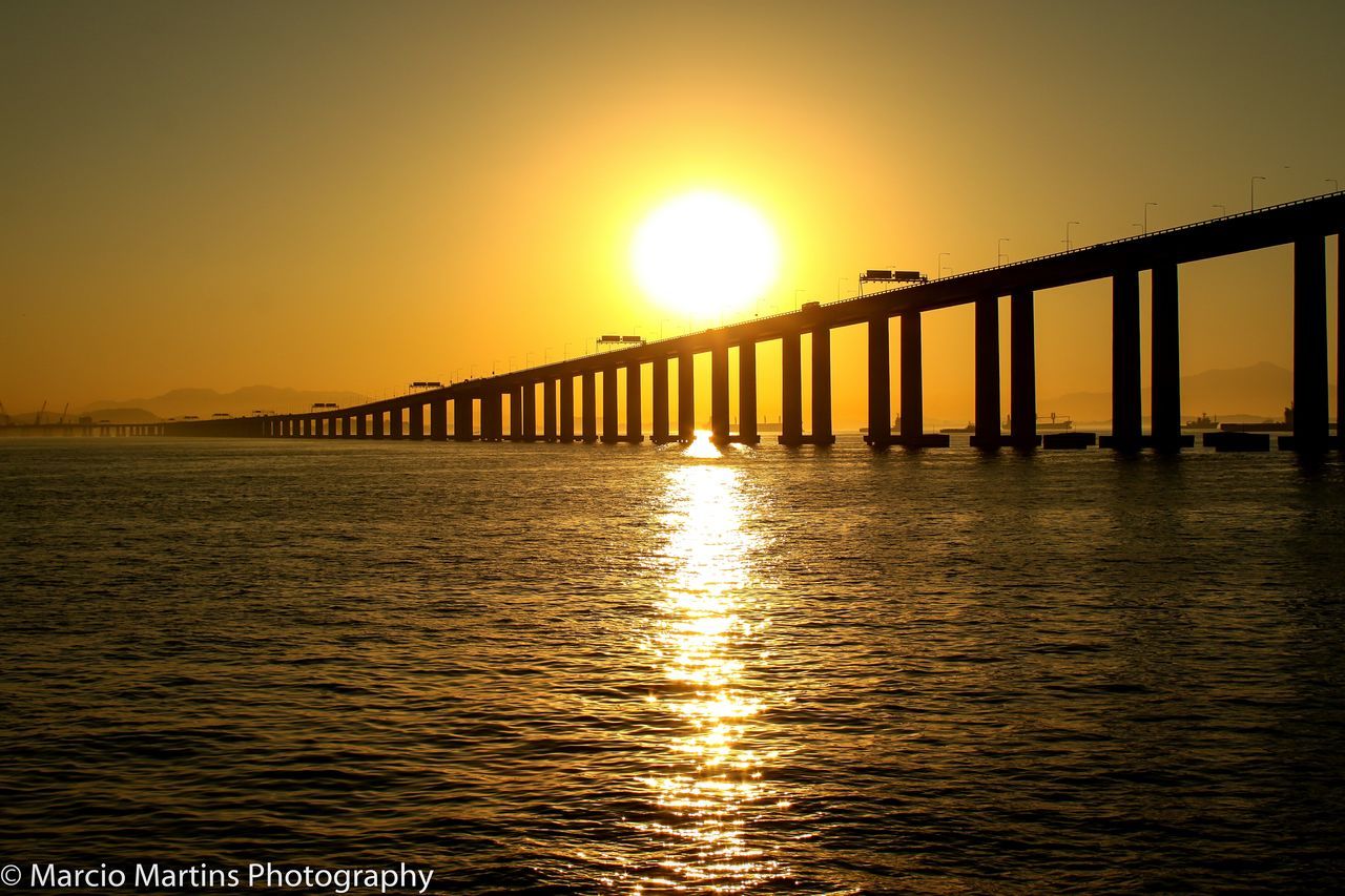 PIER OVER SEA AGAINST SUNSET SKY