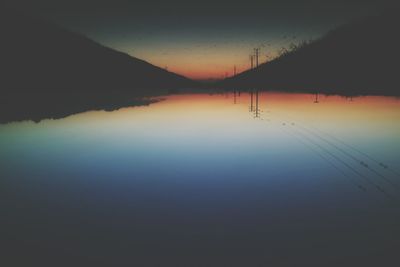 Scenic view of calm lake at sunset