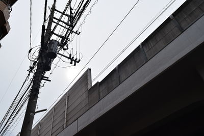 Low angle view of cables against clear sky