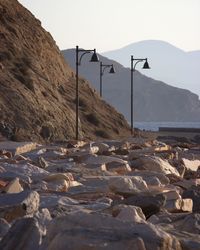 Surface level of rocks on land against clear sky