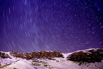 Scenic view of mountains against sky at night