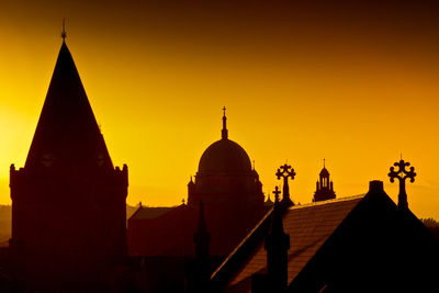 Silhouette temple against clear sky during sunset