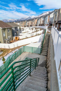 Staircase by swimming pool against buildings in city