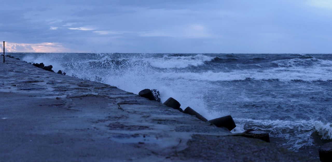 sea, water, horizon over water, wave, beach, shore, scenics, sky, motion, beauty in nature, nature, tranquil scene, tranquility, splashing, idyllic, outdoors, remote, day, cloud - sky, no people, non-urban scene, power in nature, coastline, blue, calm, cloud, seascape, travel destinations, weather, tourism