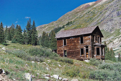 House on mountain against sky