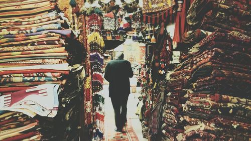 Rear view of man walking in subway