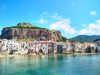 Town by sea against sky in city