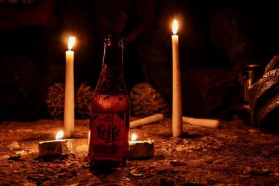 Lit candles on burning candle