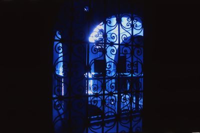 Close-up of glass window in illuminated building