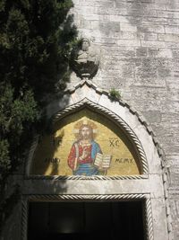 Low angle view of angel statue against building