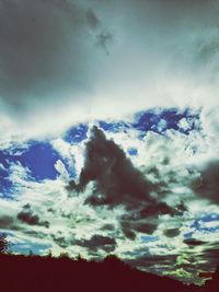 Low angle view of silhouette trees against sky