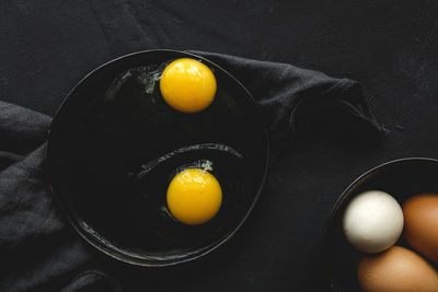 High angle view of yellow eggs in frying pan