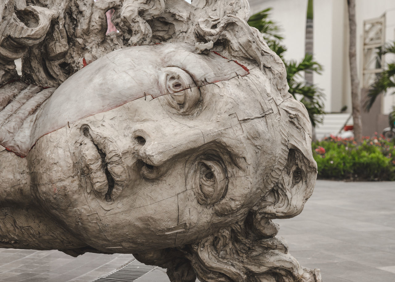 CLOSE-UP OF STATUE AGAINST WALL