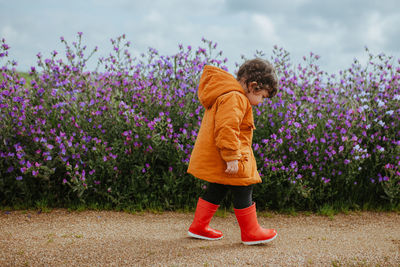 Rear view of child standing on field