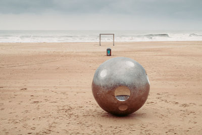 Lifeguard hut on beach against sky