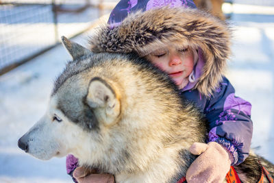 Cute girl embracing dog
