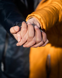 Midsection of man holding hand 