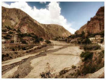 Panoramic view of road and mountains against sky