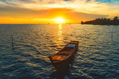 High angle view of boat moored in sea during sunrise