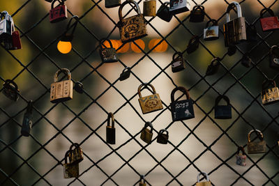 Close-up of padlocks on chainlink fence