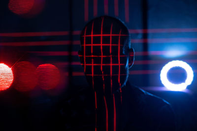 Portrait of man in illuminated nightclub
