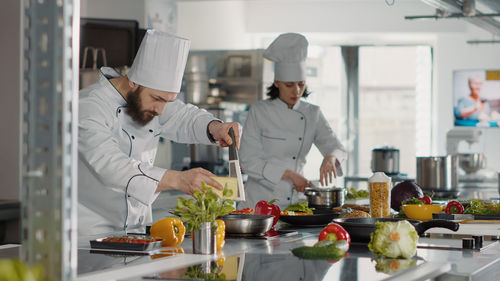 Chefs preparing food in commercial kitchen