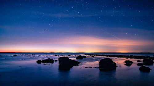 Scenic view of sea against sky at night