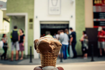 Cropped hand of person holding ice cream cone