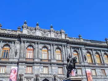 Low angle view of building against blue sky