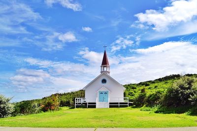 Church by building against sky