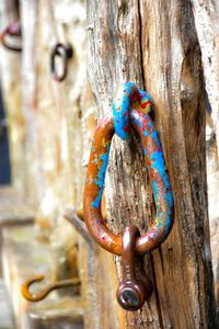 Close-up of padlock on wooden plank