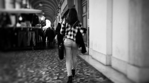 Rear view of woman walking in city