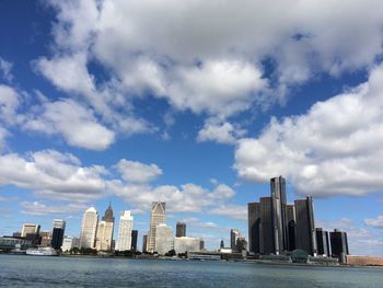 Sea by buildings against sky