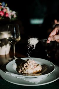 Close-up of hand holding ice cream on table