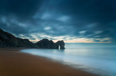 View of beach against cloudy sky