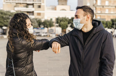 Young couple standing in city