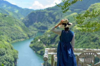 Rear view of woman looking at mountains