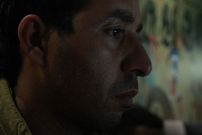 Close-up portrait of young man looking away