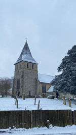Snow covered building against sky