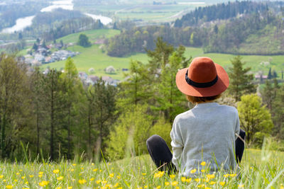 Rear view of woman standing on field