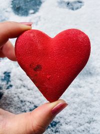 Close-up of hand holding heart shape