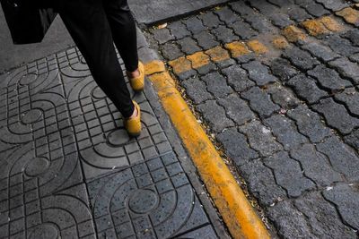 Low section of man walking on street