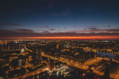 High angle view of illuminated cityscape against sky during sunset