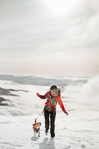 Full length of woman standing on snow covered landscape