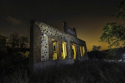 Low angle view of old building against sky at night