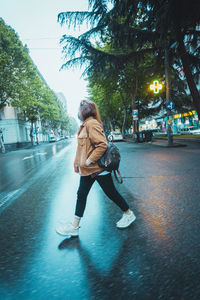 Woman with umbrella on street in city